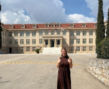 Holly Weaver standing in front of the main building on the campus of Athens College