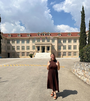 Holly Weaver standing in front of the main building on the campus of Athens College