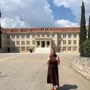 Holly Weaver standing in front of the main building on the campus of Athens College